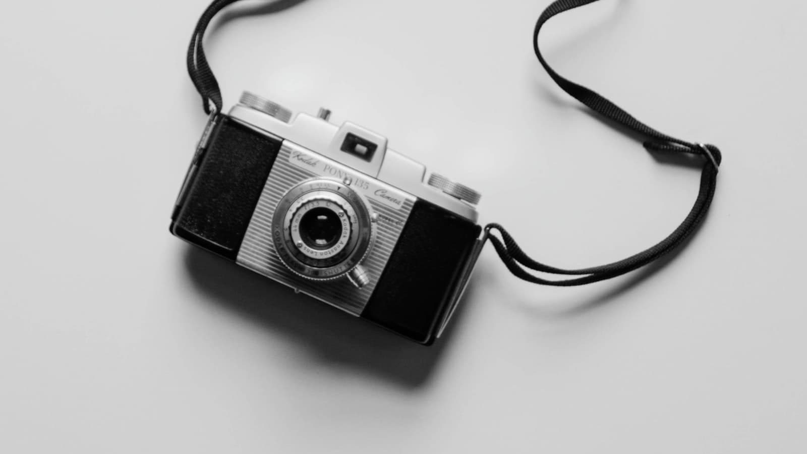 Black and white photograph of a vintage film camera on a table